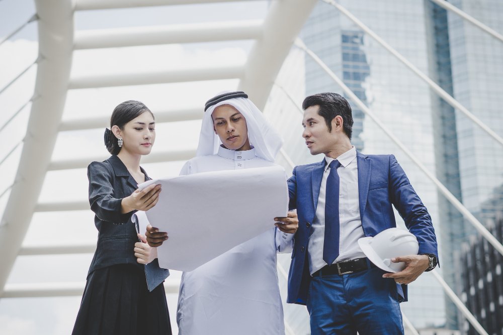 a group of people looking at a blueprint